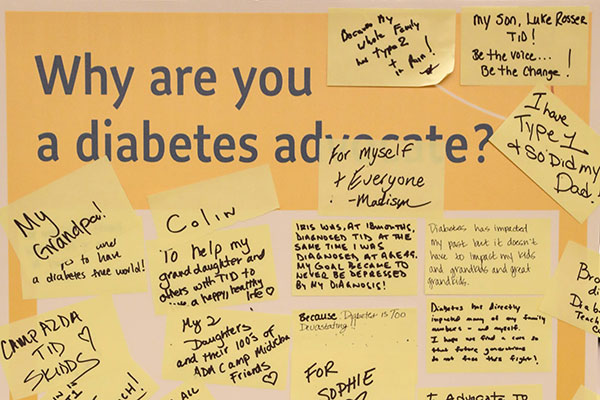 Cork board with yellow post-it notes explaining why people are diabetes advocates