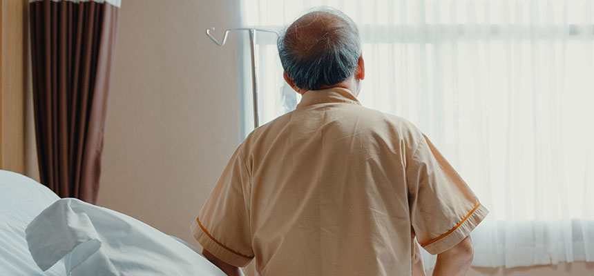 Senior patient in hospital bed looking at window
