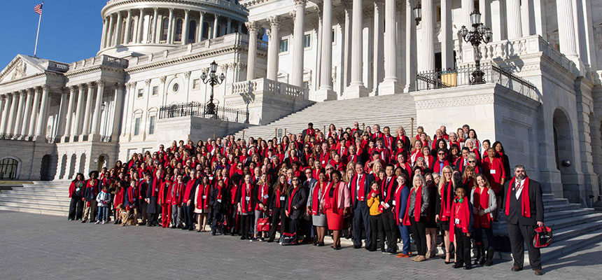 Large group of diabetes grassroots advocates dressed in red standing on the U.S. Capitol front steps.