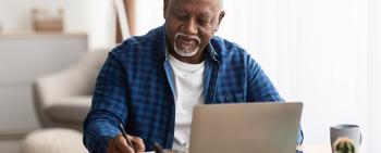 Senior African American man looking at laptop computer