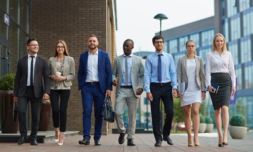 Group of seven mental health professionals walking outside of offices